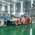 Workers operating advanced plastic bag manufacturing equipment at Hanoi Plastic Bags Manufacturing JSC in Vietnam