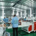 Workers producing PP woven bags in a modern manufacturing factory with advanced production lines