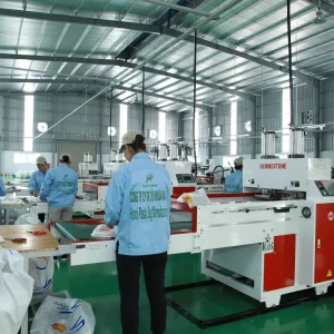 Workers producing PP woven bags in a modern manufacturing factory with advanced production lines
