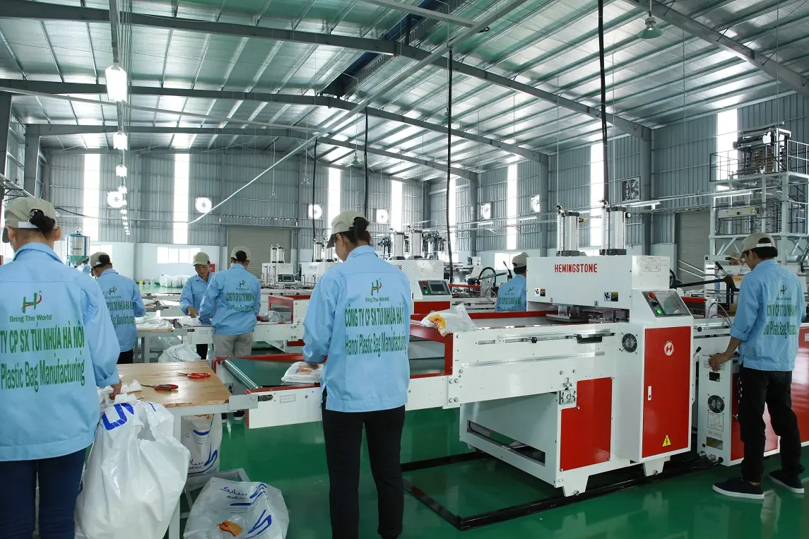Workers producing PP woven bags in a modern manufacturing factory with advanced production lines